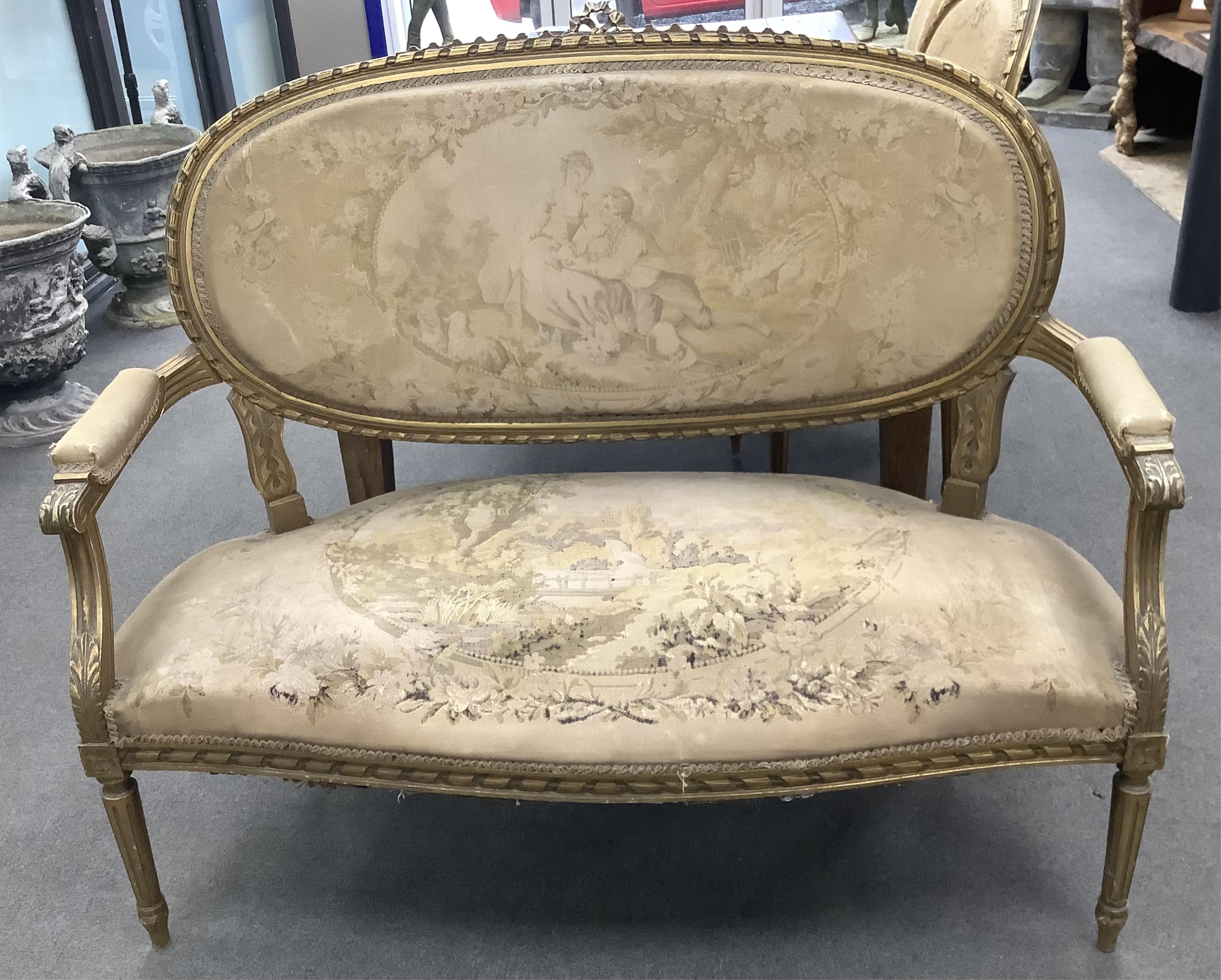 A Louis XVI style giltwood and composition three piece salon suite with tapestry upholstery, settee width 120cm, depth 54cm, height 102cm. Condition - fair